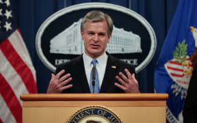 FBI Director Christopher Wray speaks during a news conference on progress in the investigation into the #REvil ransomware attacks.)