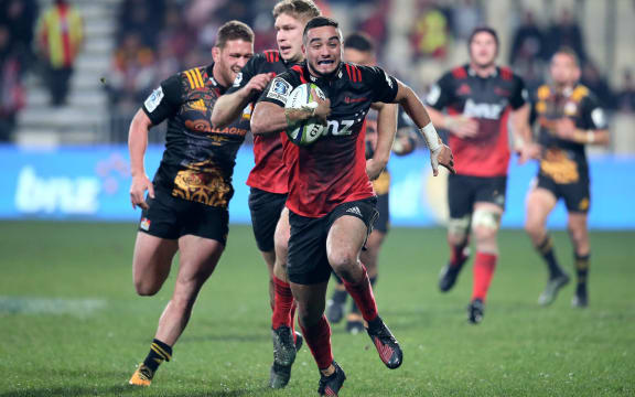 Bryn Hall of the Crusaders runs in to score his try.