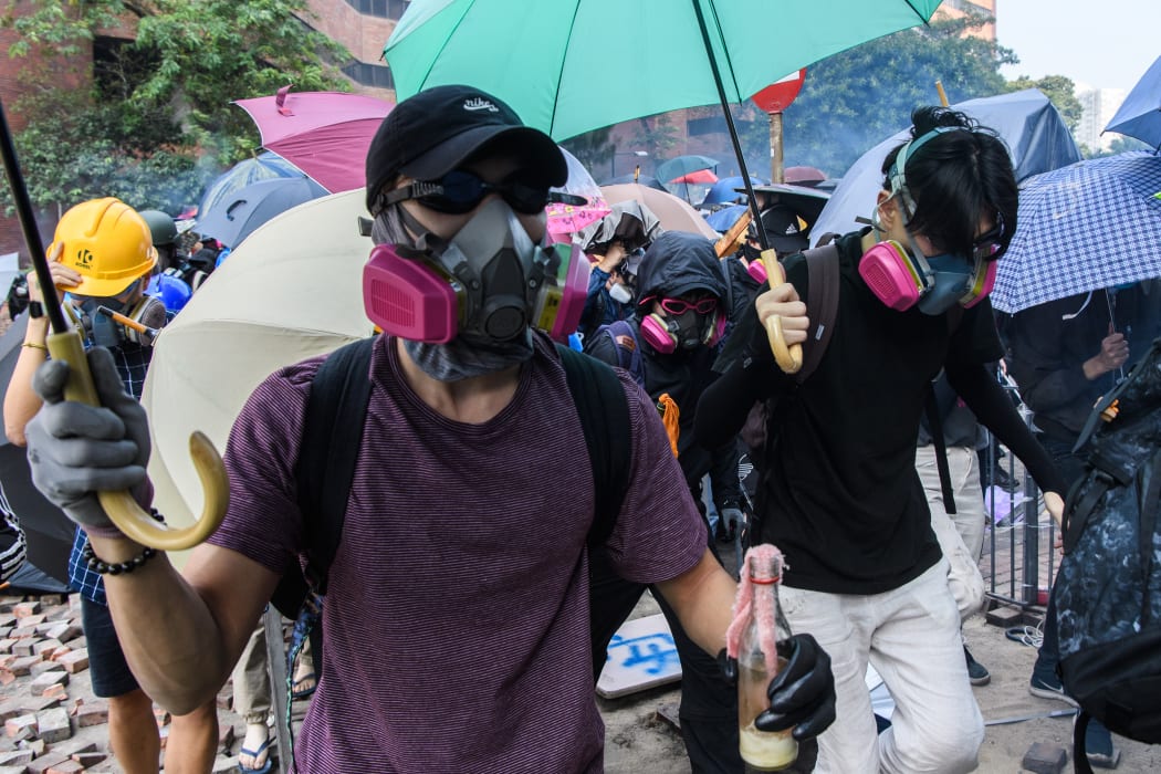 Tear gas is fired by police as protesters attempt to escape the campus of the Hong Kong Polytechnic University in the Hung Hom district of Hong Kong on November 18, 2019.