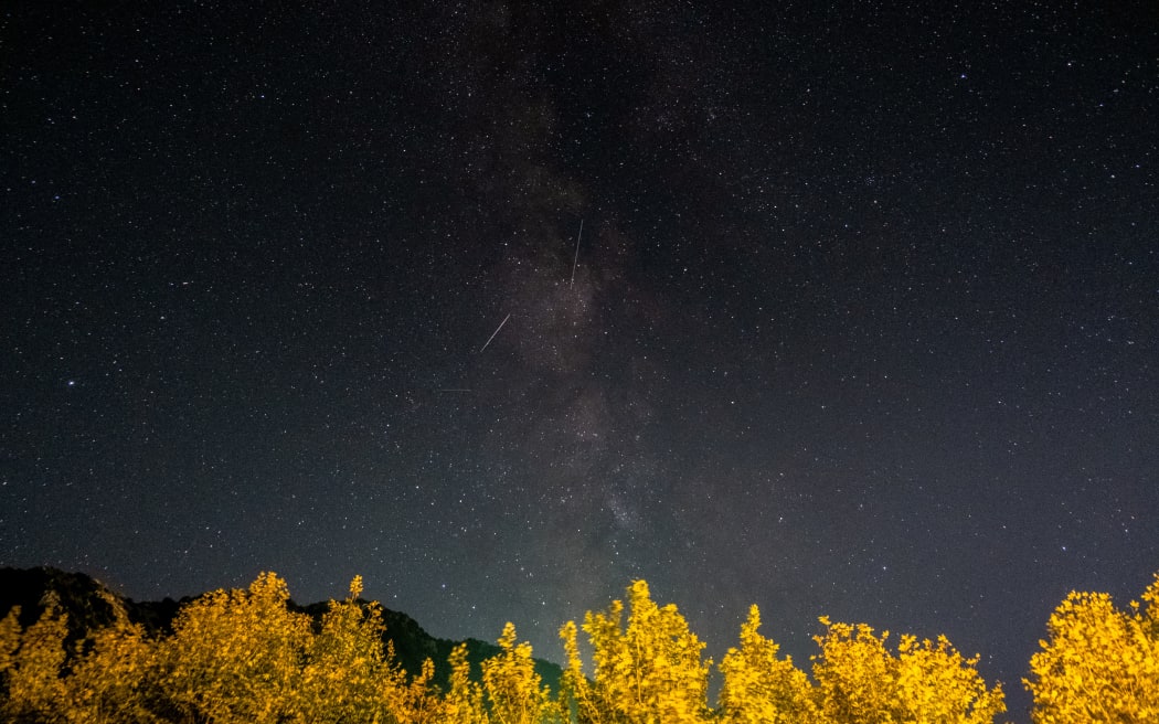 Meteors of the Orionid meteor shower streak as they cross through the Milkyway in the mountainous area of Tannourine in northern Lebanon, on October 3, 2021. (Photo by Ibrahim CHALHOUB / AFP)