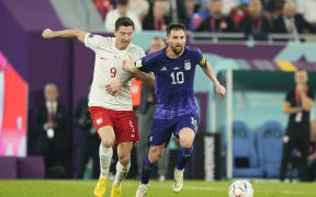 Robert Lewandowski of Poland and Lionel Messi of Argentina compete for the ball during the FIFA World Cup Qatar 2022 Group C match between Poland and Argentina at Stadium 974 on November 30, 2022 in Doha, Qatar.