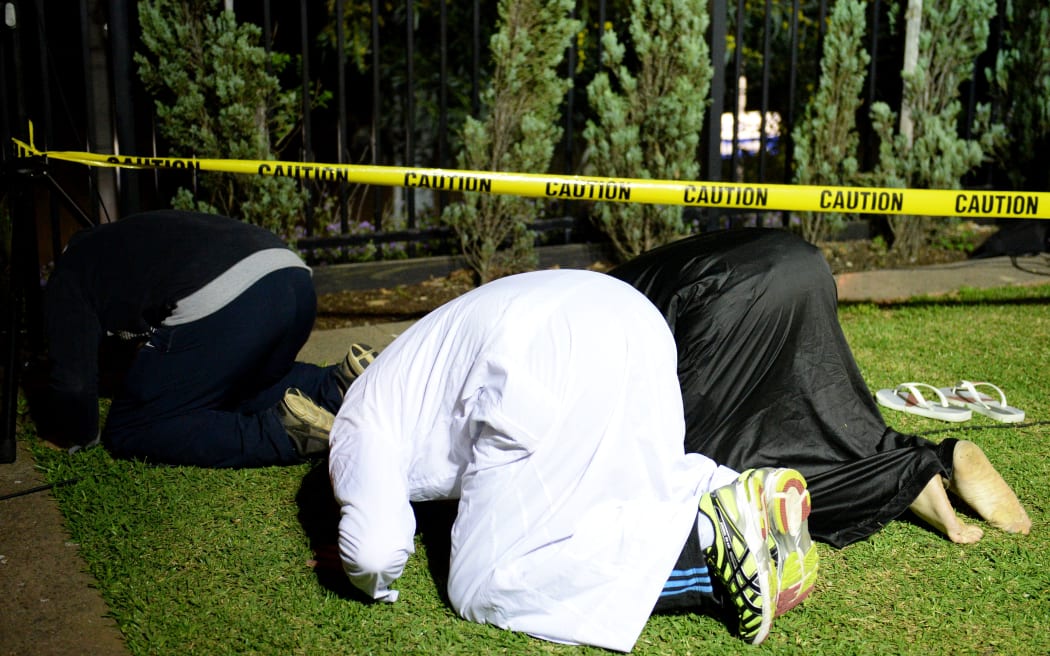 Members of the Sydney Muslim community pray prior to a rally against counter-terrorism raids across western Sydney of people with suspected links to the terror group Islamic State.