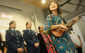 Tina Cross performs 'Walk Away' with Counties Manukau police choir and students.