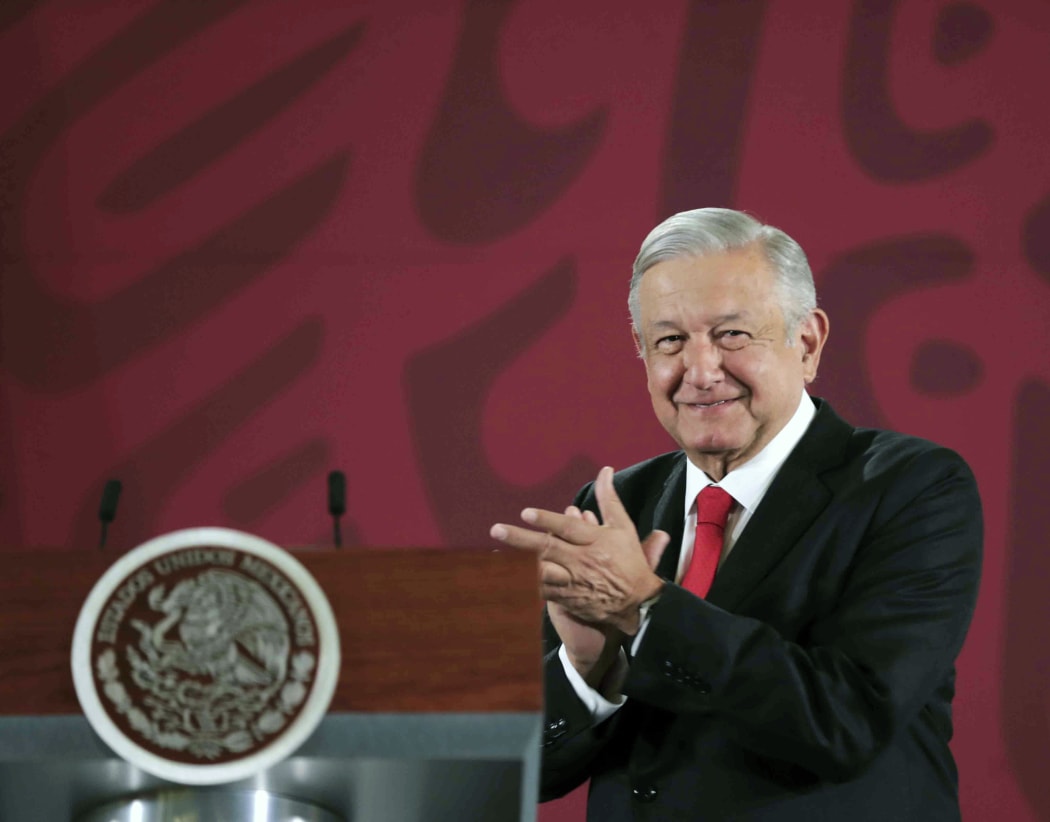 Handout picture released by the Mexican Presidency showing Mexican President Andres Manuel Lopez Obrador applauding during a press conference at the National Palace in Mexico City on December 27, 2019.