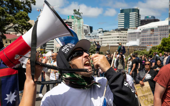 Did I mention loud? A protestor borrows someone's loud hailer to berate the front wall of the Beehive.
