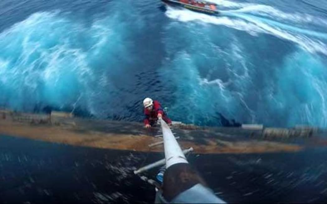 Greenpeace activist scaling Shell's oil rig Polar Pioneer in Pacific Ocean to protest against Arctic drilling.
