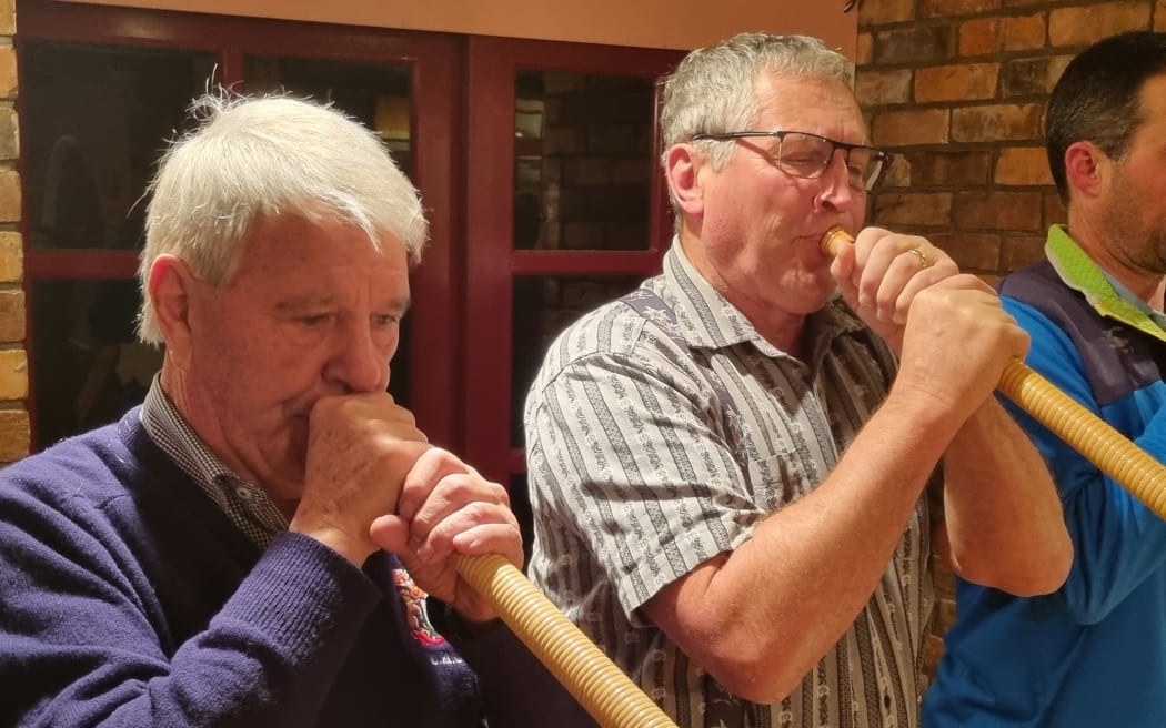 Decorated helicopter pilot Alan Beck (left) asked Othmar Hebler (right) to teach him how to play the alphorn.