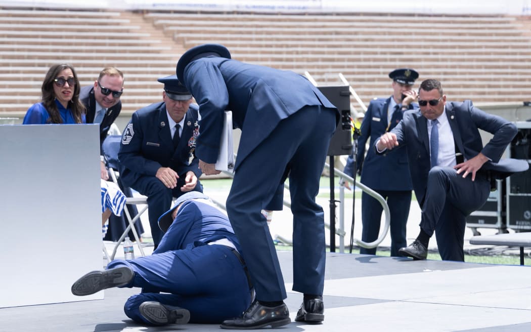 US President Joe Biden falls during the graduation ceremony at the US Air Force Academy, just north of Colorado Springs in El Paso County, Colorado, on June 1, 2023. (Photo by Brendan Smialowski / AFP)