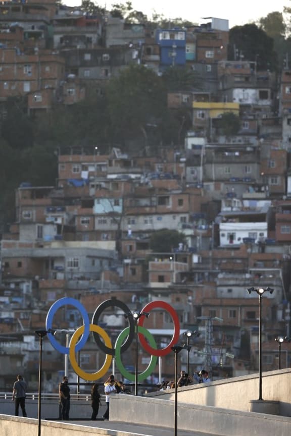 Olympic rings overlook a favela outside the Maracana stadium in Rio.