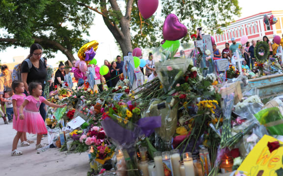 People in Uvalde visit memorials for victims of the May 24th mass shooting at Robb Elementary School, where 19 children and two teachers were killed.