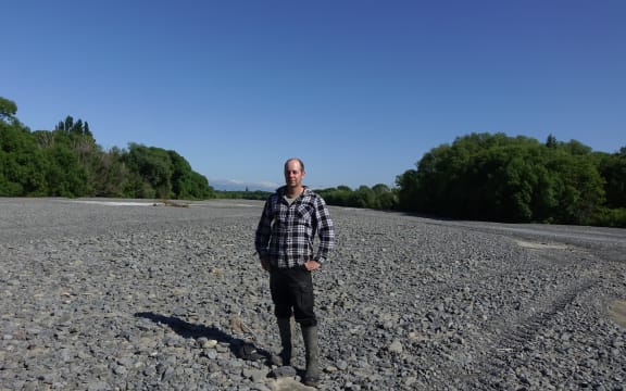 Ongaonga farmer Alistair Setter stands in the middle of the dry Waipawa River bed.