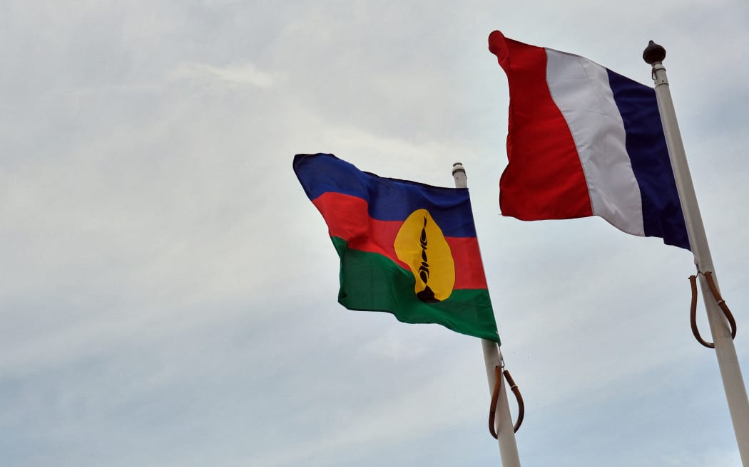 French, right, and Kanak flags.