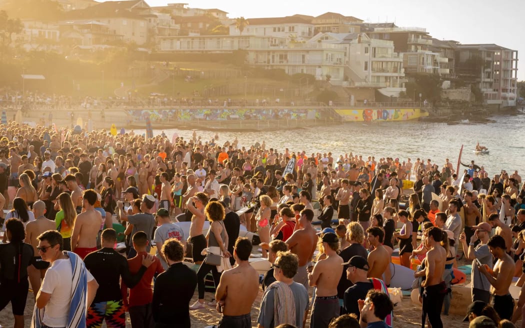 Thousands of people have gathered at Bondi Beach to paddle out into the water to hold a minute's silence for the victims killed during Sunday's attack.