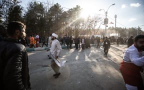 People disperse near the site where two explosions in quick succession struck a crowd marking the anniversary of the 2020 killing of Guards general Qasem Soleimani, near the Saheb al-Zaman Mosque in the southern Iranian city of Kerman on January 3, 2024. The blasts, which state television called a "terrorist attack", came with tensions running high in the Middle East a day after Hamas number two was killed in a Beirut drone strike. The blasts stuck near the Saheb al-Zaman Mosque in Kerman, Soleimani's southern hometown where he is buried, as supporters gathered to mark the fourth anniversary of his death in a US drone strike just outside Baghdad airport. (Photo by MEHR NEWS / AFP)