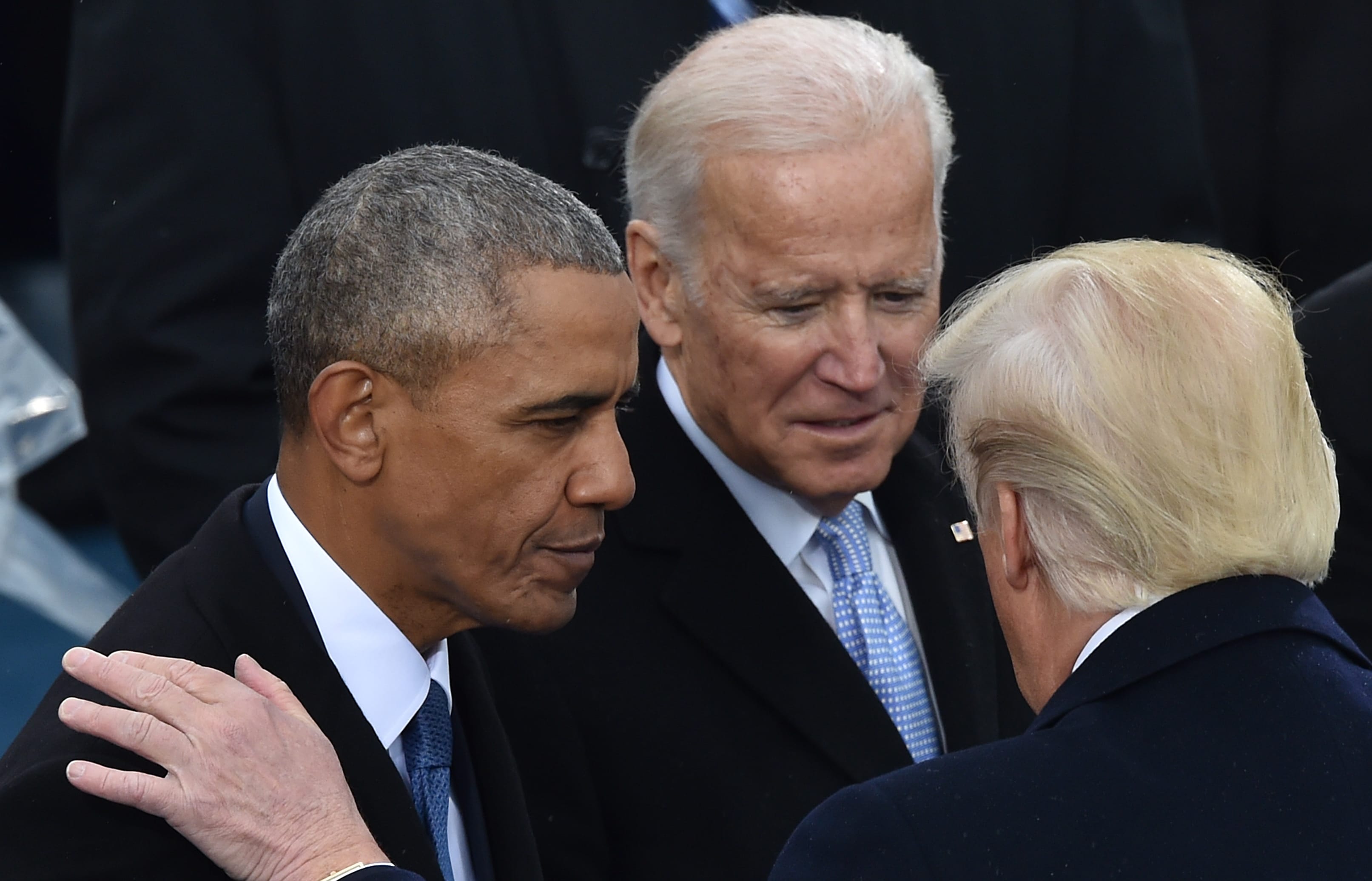 Barack Obama and Joe Biden speak with Donald Trump at his inauguration in January 2017.