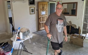 Graeme Beaufoy hard at work cleaning up his flood damaged Swanson home.