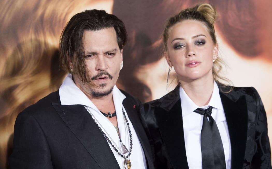 Actors Johnny Depp (L) and Amber Heard attend the Los Angeles Premiere of "The Danish Girl", in Westwood, California, on November 21, 2015.