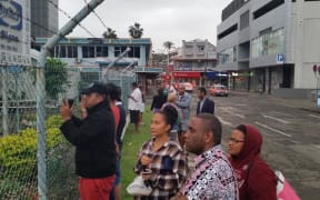Supporters and media look on as the detainees head back inside again.