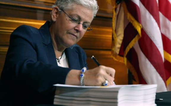 EPA Administrator Gina McCarthy signs new regulations for power plants.