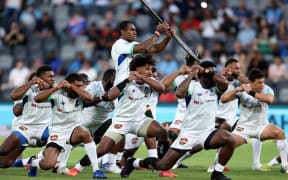 Players from Fijian Drua perform a war cry during Super Rugby