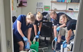 Paeroa Vet staff pump out floodwaters.