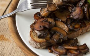 [United Kingdom] High angle close up of Chestnut mushrooms and avocado on toasted sourdough bread on a plate. (Photo by Mint Images / Mint Images / Mint Images via AFP)