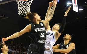 Tall Blacks forward Issac Fotu leaps for the ball against Korea.