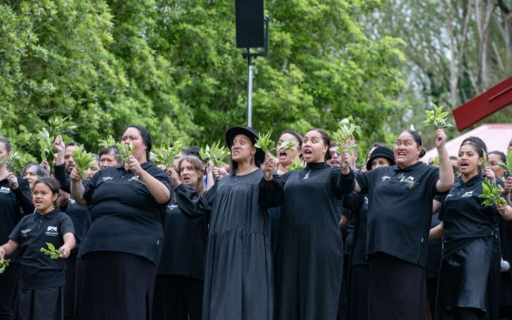 Tamzyn-Rose Pue, centre, the chair of Te Upoko o te Whenua Marae at Tarata, gives the karanga, the ceremonial call of welcome, to Treaty of Waitangi Negotiations Minister Andrew Little as he arrives to deliver the Crown apology to Ngāti Maru, flanked by her cousins Tessa-Moana Kake-Tuffley, left, and Kiri Trainor.