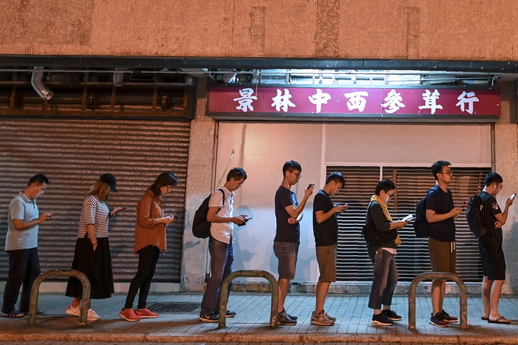 People queue to cast their vote during the district council elections in Tseung Kwan O district in Hong Kong.