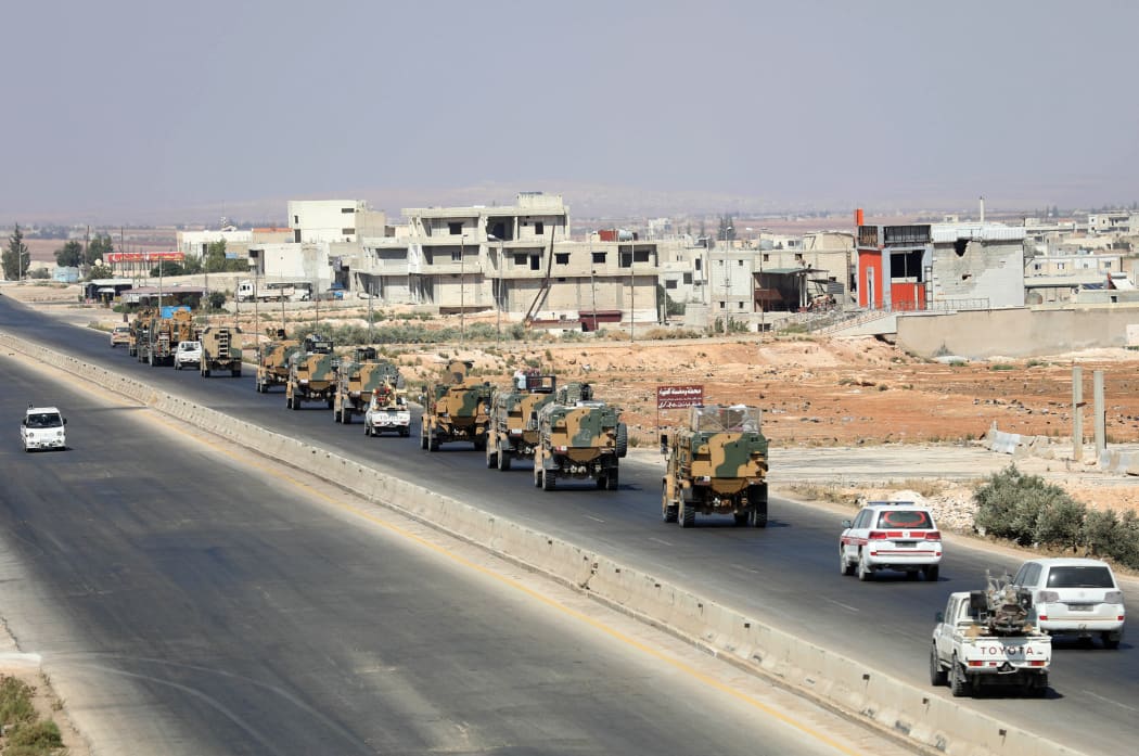 Turkish forces are seen in a convoy on a main highway between Damascus and Aleppo, near the town of Saraqib in the northern Idlib province.