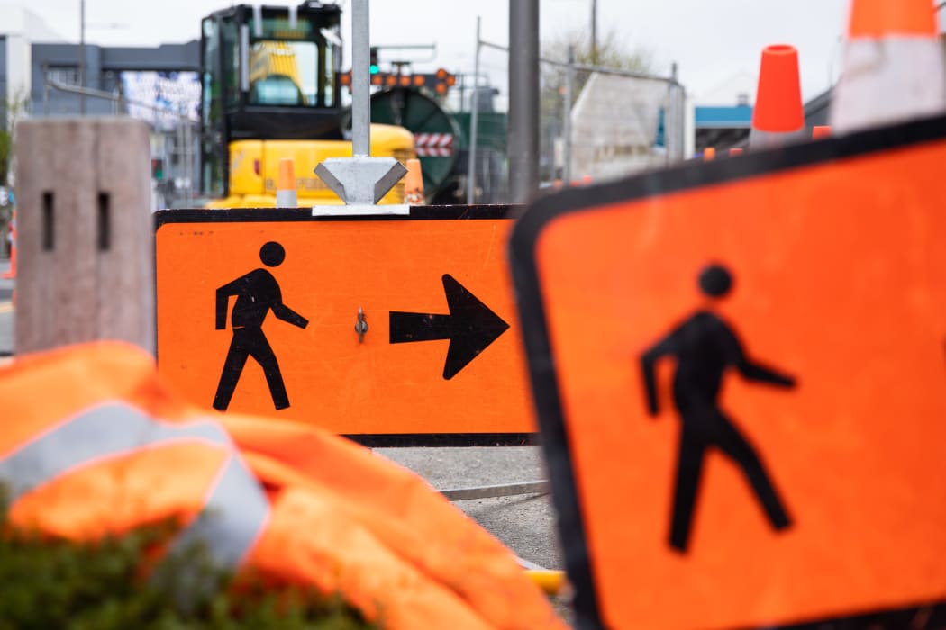 Signs alongside roadworks tell pedestrians where to go