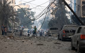 Residents check the damage following Israeli air strikes in Gaza City early on 8 October, 2023.
