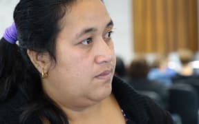 Ioane Teitiota's wife, Angua Erika, waits as her husband prepares to leave Auckland International Airport on Wednesday 23 September 2015. The family's application to be considered refugees from the effects of climate change in Kiribati has been declined, and Mr Teitiota is being deported today.