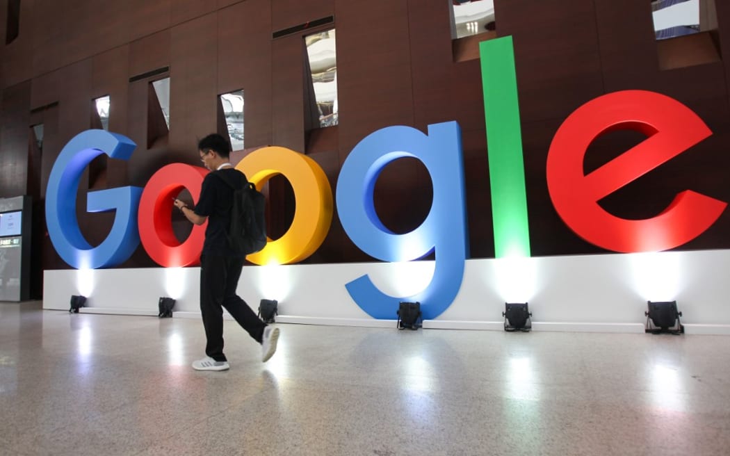 A guy walks past the Google logo set up for the Google Developers Day in Shanghai, China, 10 September 2019.
