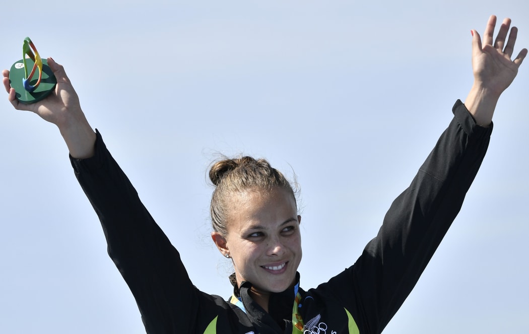 New Zealand's Lisa Carrington celebrates on the podium of the Women's Kayak Single (K1) 200m final at the Lagoa Stadium during the Rio 2016 Olympic Games in Rio de Janeiro on August 16, 2016.