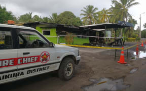 Fire authorities attend the site of one of the fires in Arorangi