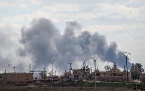 Smoke billows after shelling on the IS group's last holdout of Baghuz.