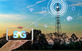 hand holding mobile smart phone using 5G network interface and icon