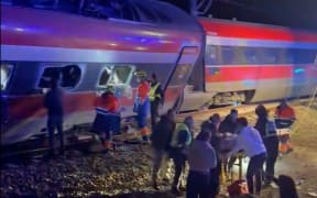This video grab taken from UGC images posted on social media and verified by AFPTV teams in Madrid, shows emergency personnel working after a train accident in Adamuz, southern Spain, on January 18, 2026. At least 21 people died in a train accident near Adamuz, in the Spanish province of Cordoba (south), when a train derailed and collided with another convoy traveling on the opposite track, the Civil Guard told AFP. A train from the Spanish company Iryo traveling from the Andalusian city of Malaga to Madrid 'derailed' near Adamuz, 'encroaching on the adjacent track' where it collided with another train that 'also derailed,' stated the Railway Infrastructure Administrator (Adif), a public entity under the Ministry of Transport, on X. (Photo by -UGC / @eleanorinthesky (via X) / AFP) / RESTRICTED TO EDITORIAL USE – MANDATORY CREDIT «  AFP PHOTO / @ELEANORINTHESKY (VIA X) » - NO SALES NO MARKETING NO ADVERTISING CAMPAIGNS – DISTRIBUTED AS A SERVICE TO CLIENTS [ NO ARCHIVE ]