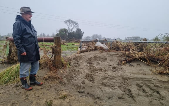 Resident Geoff Grocott who lives nearby surveying the damage at Motueka River.