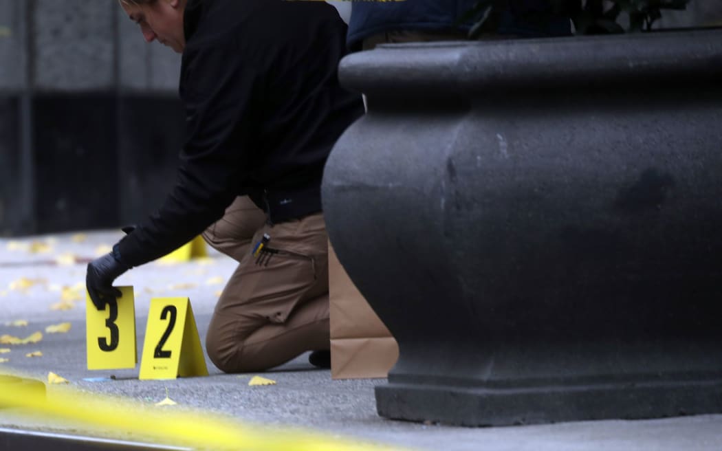 Police place bullet casing markers outside of a Hilton Hotel in Midtown Manhattan in New York, where United Healthcare CEO Brian Thompson was fatally shot on Wednesday, December 4.