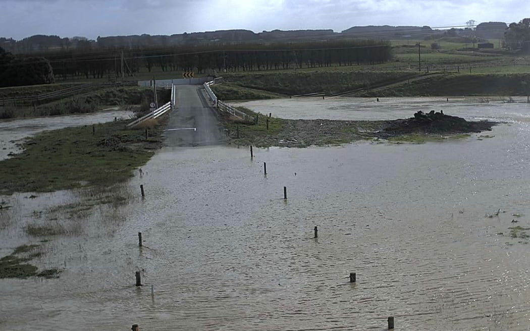 Hoihere Road near Ōroua River in Manawatu-Whanganui, with the flood barrier deployed on the far side of the bridge during flooding on 21 May, 2023.