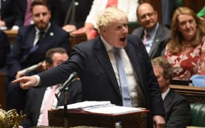 A handout photograph released by the UK Parliament shows Britain's Prime Minister Boris Johnson speaking during the weekly Prime Minister's Questions (PMQs) session in the House of Commons in London on September 8, 2021.