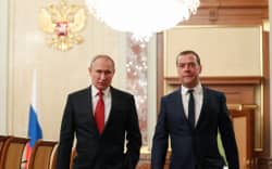 Russian President Vladimir Putin and Russia’s Security Council deputy chairman Dmitry Medvedev walk before a meeting with members of the government in Moscow on January 15, 2020.