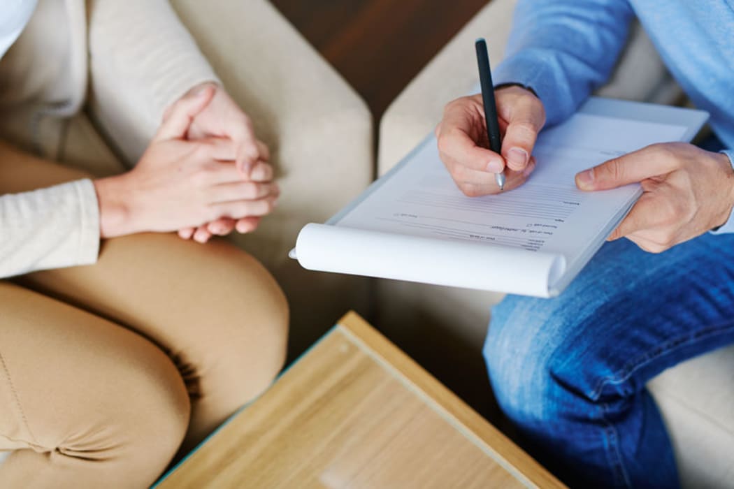 hands of a psychiatrist filling in a document