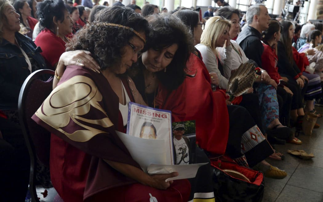 Attendees console each other at the closing ceremony for the National Inquiry into Missing and Murdered Indigenous Women and Girls in Gatineau, Quebec, on Monday, June 3, 2019.