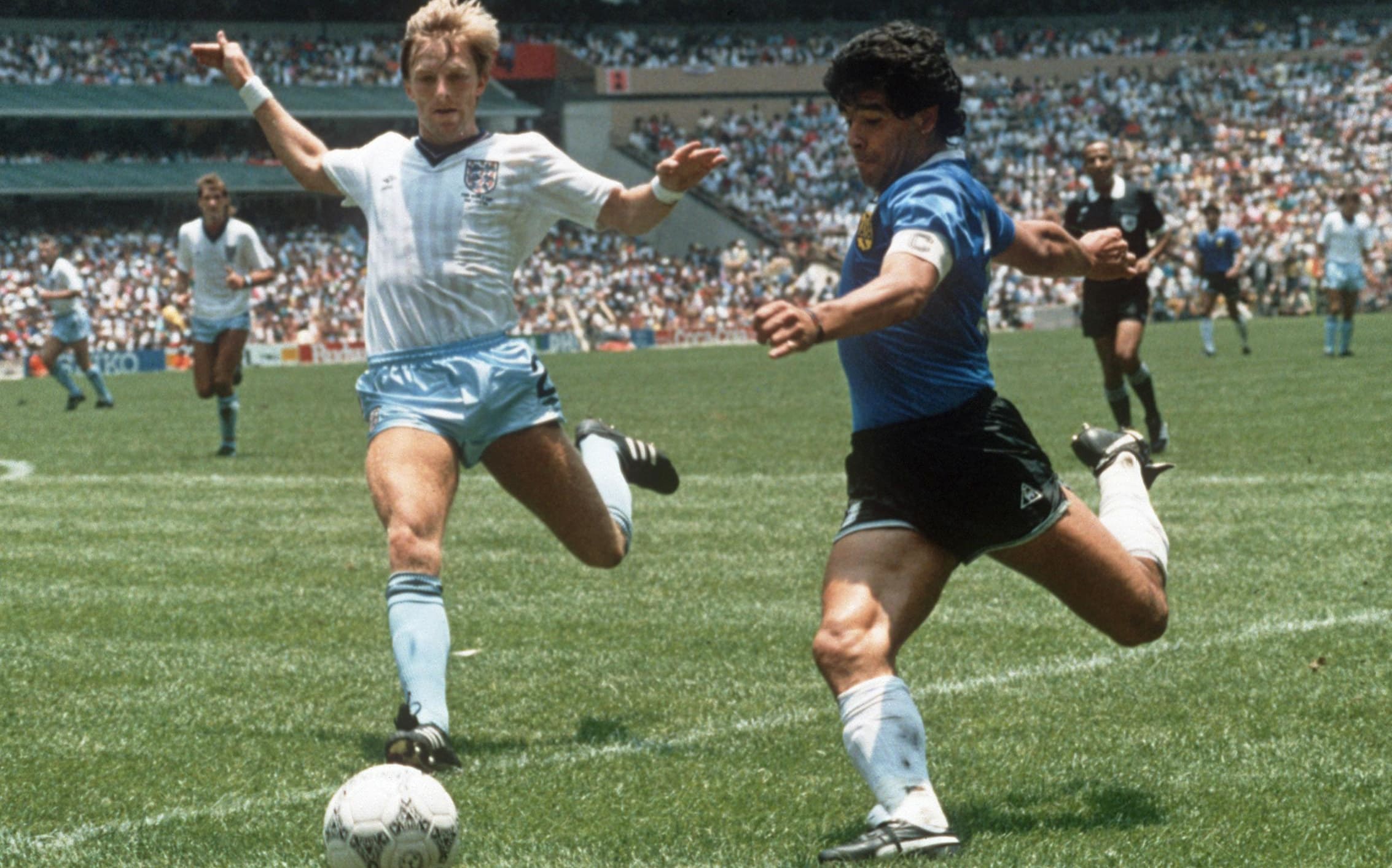 Argentinian forward Diego Maradona gets ready to cross the ball under pressure from English defender Gary Stevens during the World Cup quarterfinal soccer match between Argentina and England on June 1986.