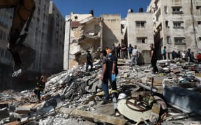 Palestinians inspect a destroyed house, after it was struck by Israeli strikes, in Gaza City this week.