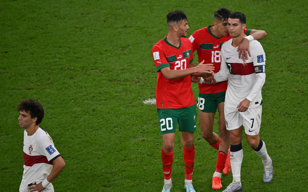 Morocco's defender Achraf Dari and Morocco's defender Jawad El Yamiq greet Portugal's Cristiano Ronaldo as he leaves the field after losing to Morocco 1-0 in the Qatar 2022 World Cup quarter-final football match between Morocco and Portugal on December 10, 2022.