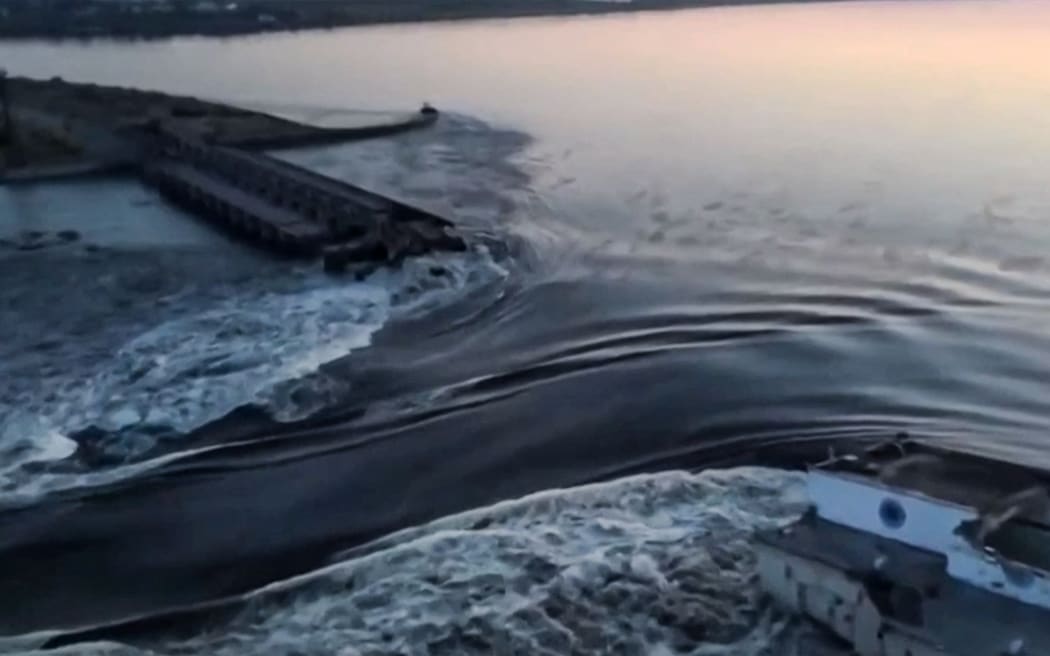 This screen grab from a video posted on Ukraine's President Volodymyr Zelensky's Twitter account on 6 June 2023 shows an aerial view of the dam of the Kakhovka hydroelectric power station after it was partially destroyed.